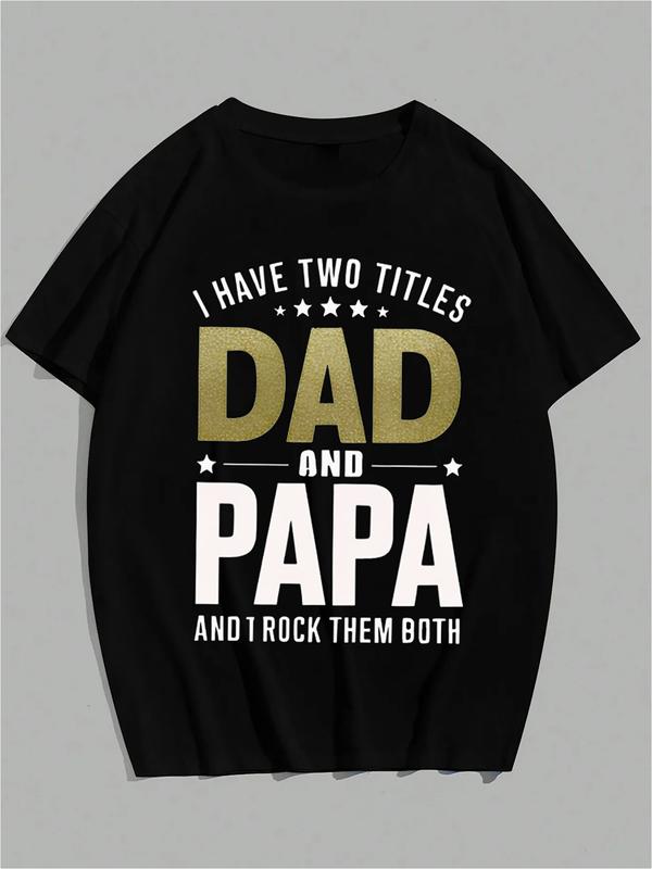Black T-shirt with bold text reading “I Have Two Titles: Dad and Papa and I Rock Them Both” in gold and white lettering