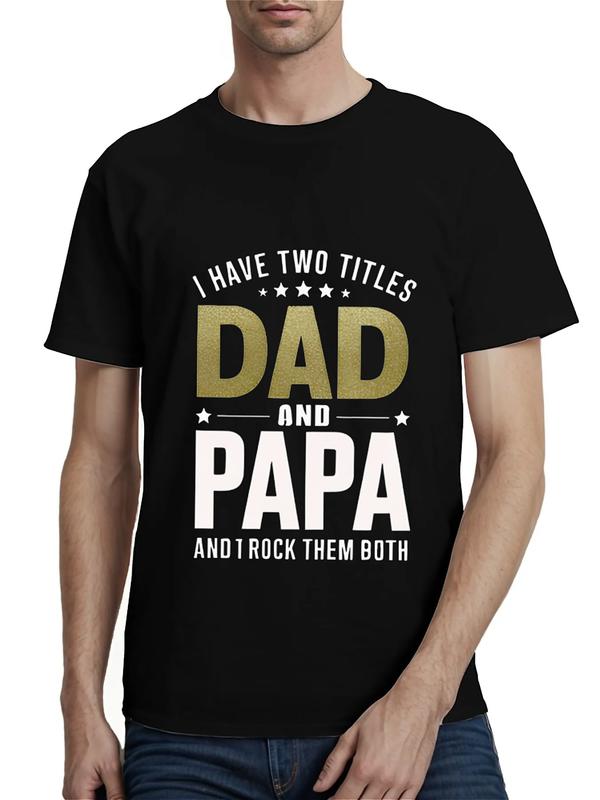 Black T-shirt with bold text reading “I Have Two Titles: Dad and Papa and I Rock Them Both” in gold and white lettering