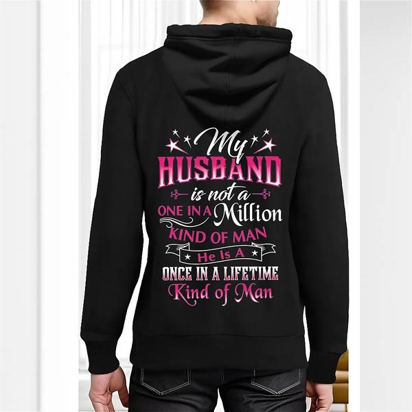 Back view of black hoodie featuring decorative white, pink, and purple text reading “My husband is not a one in a million kind of man, he is a once in a lifetime kind of man” with star graphics