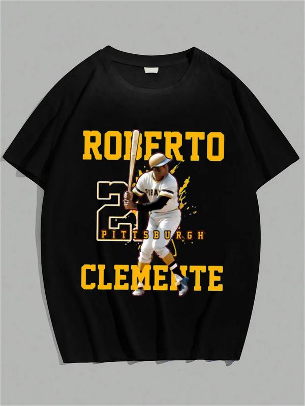 Black T-shirt featuring Roberto Clemente in a batting stance, with bold yellow text “ROBERTO CLEMENTE,” number 21 graphic, and “PITTSBURGH” across the design