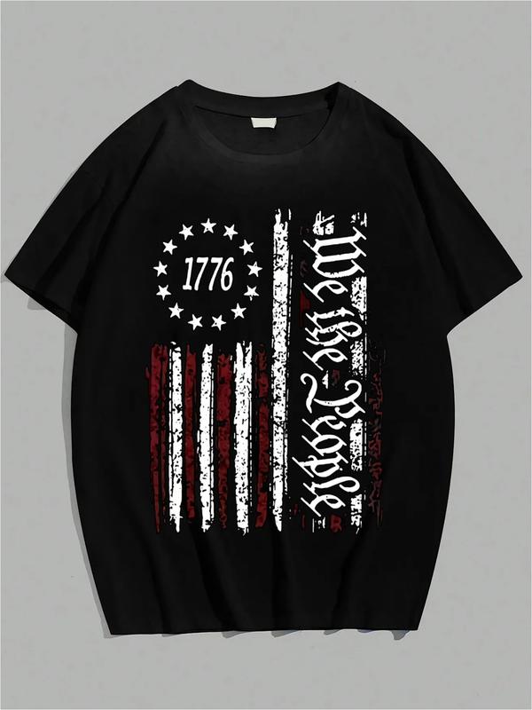 Black T-shirt featuring a distressed vertical American flag with red and white stripes, 13 stars around “1776,” and ornate vertical text reading “We the People”